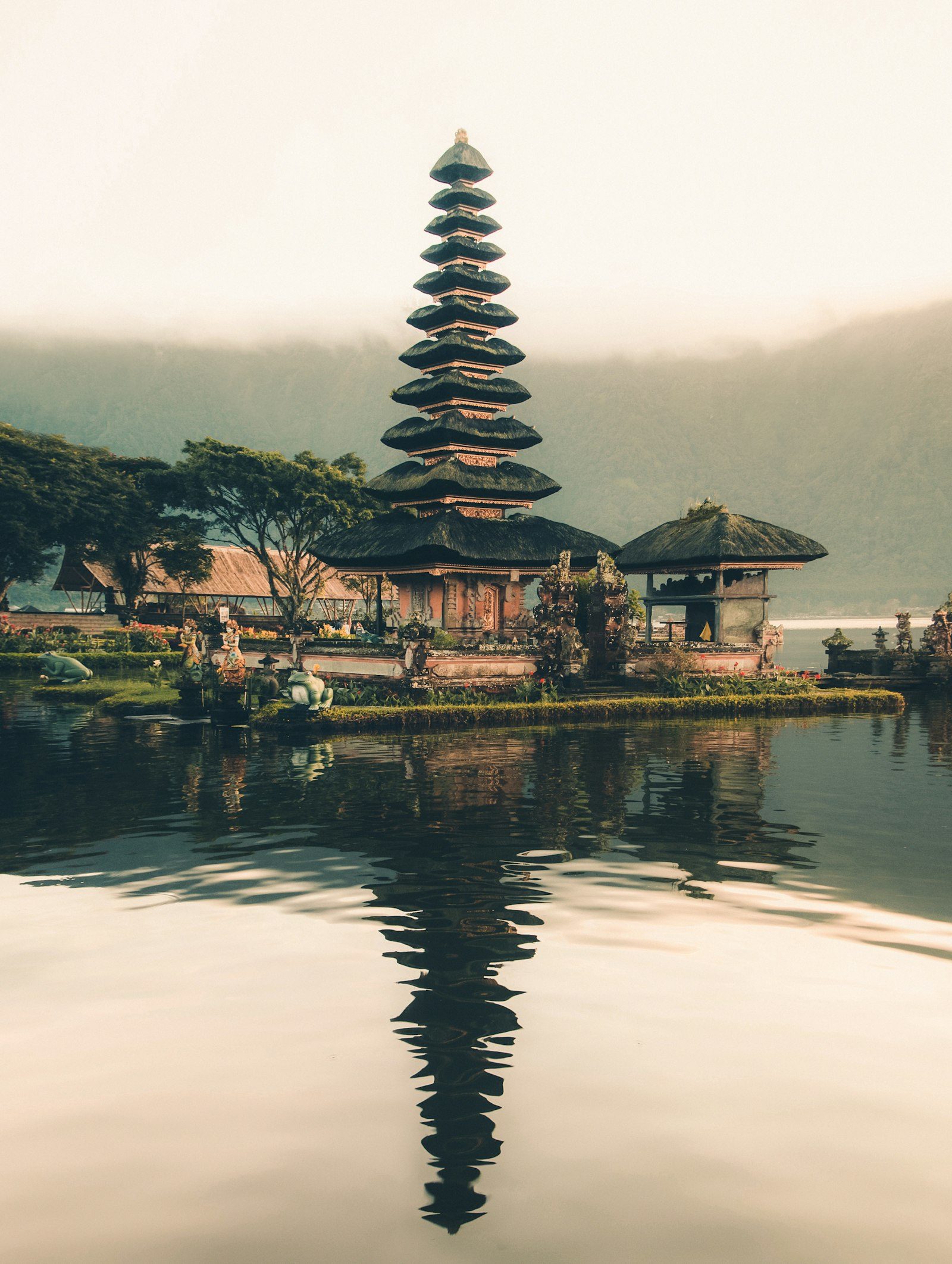 A Balinese lake temple and its pagoda mirrored in still water